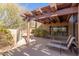 Serene covered patio featuring lounge chairs and a lush garden view at 9200 E Whitethorn Cir # 601, Scottsdale, AZ 85266