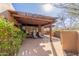 Cozy patio with lounge chairs and a natural wood pergola, perfect for relaxation at 9200 E Whitethorn Cir # 601, Scottsdale, AZ 85266