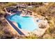 Backyard pool with hot tub, desert landscaping, and covered patio with seating at 9200 E Whitethorn Cir # 601, Scottsdale, AZ 85266