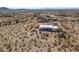 Desert property showcasing a contemporary home surrounded by natural vegetation, offering privacy and scenic views at 10020 W Tortalita Way, Casa Grande, AZ 85194