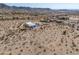 Wide desert landscape featuring a modern, single-story home with ample parking, and mountain views at 10020 W Tortalita Way, Casa Grande, AZ 85194