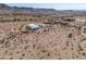 Wide desert landscape featuring a modern, single-story home with ample parking and defined property lines at 10020 W Tortalita Way, Casa Grande, AZ 85194