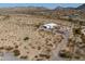 Expansive aerial view of a modern home situated in a desert landscape, showcasing its privacy and natural surroundings at 10020 W Tortalita Way, Casa Grande, AZ 85194