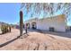 This home features a large backyard with desert landscaping, mature cacti, and mountain views at 10020 W Tortalita Way, Casa Grande, AZ 85194