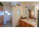 A bathroom featuring a tiled counter, wood cabinets, sink, toilet, and decorative fish art at 10020 W Tortalita Way, Casa Grande, AZ 85194