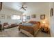 Cozy bedroom with natural light, decorative artwork, and a comfortable bed at 10020 W Tortalita Way, Casa Grande, AZ 85194