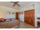 Bedroom featuring natural light, built in closets, and a comfortable bed at 10020 W Tortalita Way, Casa Grande, AZ 85194