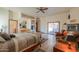 Primary bedroom with ceiling fan, tile floor, TV, sitting area and patio access at 10020 W Tortalita Way, Casa Grande, AZ 85194