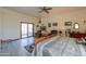 A spacious primary bedroom features wood floors, a ceiling fan, and a sliding glass door to the patio at 10020 W Tortalita Way, Casa Grande, AZ 85194