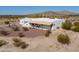 Southwest-style home featuring a stucco exterior, tile roof, gravel landscaping, and views of surrounding mountains at 10020 W Tortalita Way, Casa Grande, AZ 85194