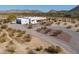 Stylish home featuring a stucco exterior, gravel landscaping, and a circular driveway for ample parking at 10020 W Tortalita Way, Casa Grande, AZ 85194