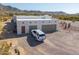 Modern home featuring a two-car garage, flat roof, and desert landscaping at 10020 W Tortalita Way, Casa Grande, AZ 85194