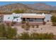 Stunning southwestern home featuring a stucco exterior, covered patio, gravel landscaping, and beautiful desert surroundings at 10020 W Tortalita Way, Casa Grande, AZ 85194