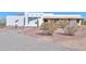 Charming single-story home with a desert landscape and a gravel driveway at 10020 W Tortalita Way, Casa Grande, AZ 85194