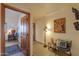 Hallway featuring beautiful tile flooring, a statement art piece, and decorative lamp at 10020 W Tortalita Way, Casa Grande, AZ 85194