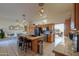 Open kitchen features custom cabinets, large island with seating, and stainless steel appliances at 10020 W Tortalita Way, Casa Grande, AZ 85194