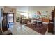 Expansive living room featuring tile flooring, neutral walls, and abundant natural light from glass block windows at 10020 W Tortalita Way, Casa Grande, AZ 85194