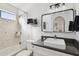 Stylish bathroom featuring a shower-tub combo, modern vanity with a vessel sink, and decorative mirror at 1025 E Highland Ave # 6, Phoenix, AZ 85014