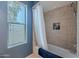 Clean bathroom featuring a tiled shower, tub and a blue accent wall for a modern look at 10426 N 10Th St # 1, Phoenix, AZ 85020
