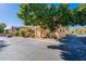 View of the front exterior of the townhouse with mature trees and desert landscaping at 10426 N 10Th St # 1, Phoenix, AZ 85020