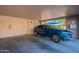 Private garage featuring a blue car parked inside and an electric charging station at 10426 N 10Th St # 1, Phoenix, AZ 85020