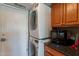 Convenient laundry area with stacked washer/dryer and storage cabinets with black countertop at 10426 N 10Th St # 1, Phoenix, AZ 85020