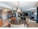 Open-concept living space with modern lighting, dining area, and a glimpse of the kitchen and stairs at 10426 N 10Th St # 1, Phoenix, AZ 85020