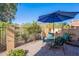 Cozy patio area with a table, chairs, and a blue umbrella, ideal for outdoor relaxing at 10426 N 10Th St # 1, Phoenix, AZ 85020