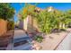 Side yard with a block wall, mature fruit tree, and desert landscaping at 10426 N 10Th St # 1, Phoenix, AZ 85020