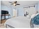 Comfortable bedroom with wood-look floors, barn door and soft blue walls at 11434 W St John Rd, Surprise, AZ 85378