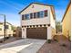 Charming two-story home with a well-manicured front yard and a private driveway leading to a two-car garage at 11434 W St John Rd, Surprise, AZ 85378