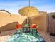 Charming patio featuring outdoor seating under a large umbrella, perfect for relaxing and enjoying the outdoor space at 11434 W St John Rd, Surprise, AZ 85378