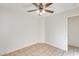 A bright bedroom features neutral tile flooring and a modern ceiling fan at 11825 W Flanagan St, Avondale, AZ 85323