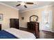 Bedroom with hardwood floors, tan walls, and dark wood furniture at 13655 W Junipero Dr, Sun City West, AZ 85375