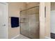 Bathroom featuring a glass enclosed shower with tile surround and a blue towel at 13655 W Junipero Dr, Sun City West, AZ 85375