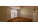 Simple bedroom with wood flooring, plantation shutters and neutral walls, creating a tranquil space at 13911 W Gable Hill Dr, Sun City West, AZ 85375