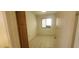 Small bedroom with tiled floors, a window, and built-in cabinet at 13911 W Gable Hill Dr, Sun City West, AZ 85375