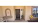 Cozy front porch featuring seating, decor, a secure screen door, and a 'dog on duty' warning sign at 13911 W Gable Hill Dr, Sun City West, AZ 85375
