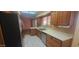 Well-lit kitchen featuring stainless steel appliances, light countertops, and wood cabinetry at 13911 W Gable Hill Dr, Sun City West, AZ 85375