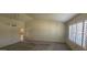 Bright living room featuring a large window, neutral carpet, and a vaulted ceiling, offering a spacious feel at 13911 W Gable Hill Dr, Sun City West, AZ 85375