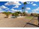 Backyard features pool, basketball hoop, green area, and tropical palms, perfect for entertaining at 15357 W Post Cir, Surprise, AZ 85374