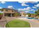 Spacious backyard featuring a pristine pool, lush green area, and low-maintenance landscaping at 15357 W Post Cir, Surprise, AZ 85374