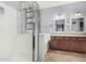 A primary bathroom with a glass-enclosed shower, dual sinks and updated finishes at 15357 W Post Cir, Surprise, AZ 85374