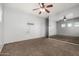 Bedroom featuring a large mirror wall, ceiling fan and neutral flooring at 15357 W Post Cir, Surprise, AZ 85374