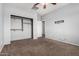 Cozy bedroom features a ceiling fan, closet, and TV mount at 15357 W Post Cir, Surprise, AZ 85374