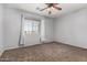 Neutral bedroom featuring a ceiling fan and a bright window, offering a serene retreat at 15357 W Post Cir, Surprise, AZ 85374