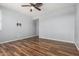 Empty bedroom with wood look flooring, ceiling fan, and neutral paint at 15357 W Post Cir, Surprise, AZ 85374