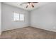 Bright bedroom with a large window and neutral carpet flooring, creating a serene retreat at 15357 W Post Cir, Surprise, AZ 85374