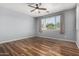 A bright bedroom featuring laminate floors, large windows, and neutral paint at 15357 W Post Cir, Surprise, AZ 85374