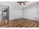 An empty bedroom features laminate floors, neutral paint, and a ceiling fan at 15357 W Post Cir, Surprise, AZ 85374